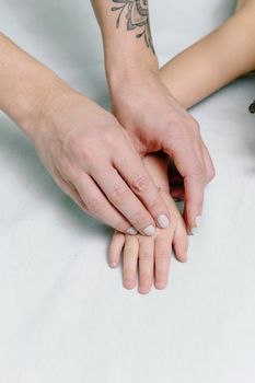 A close-up of a tender moment between a mother and child, showcasing a hand massage.