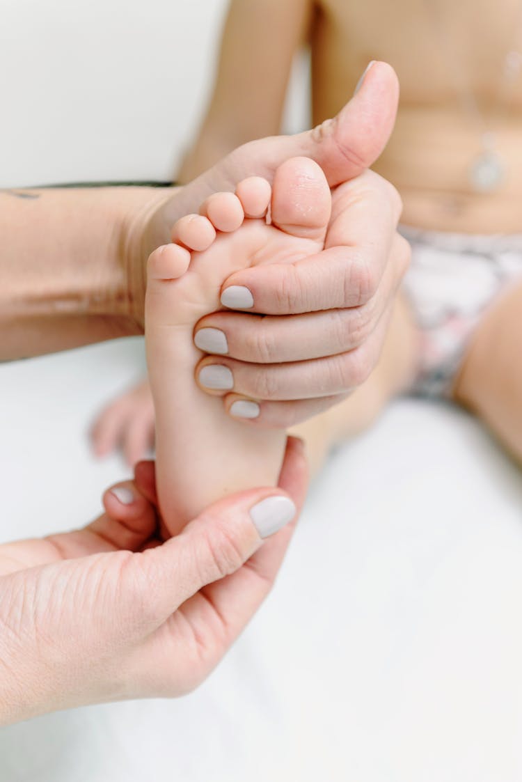 Person Massaging Baby Feet