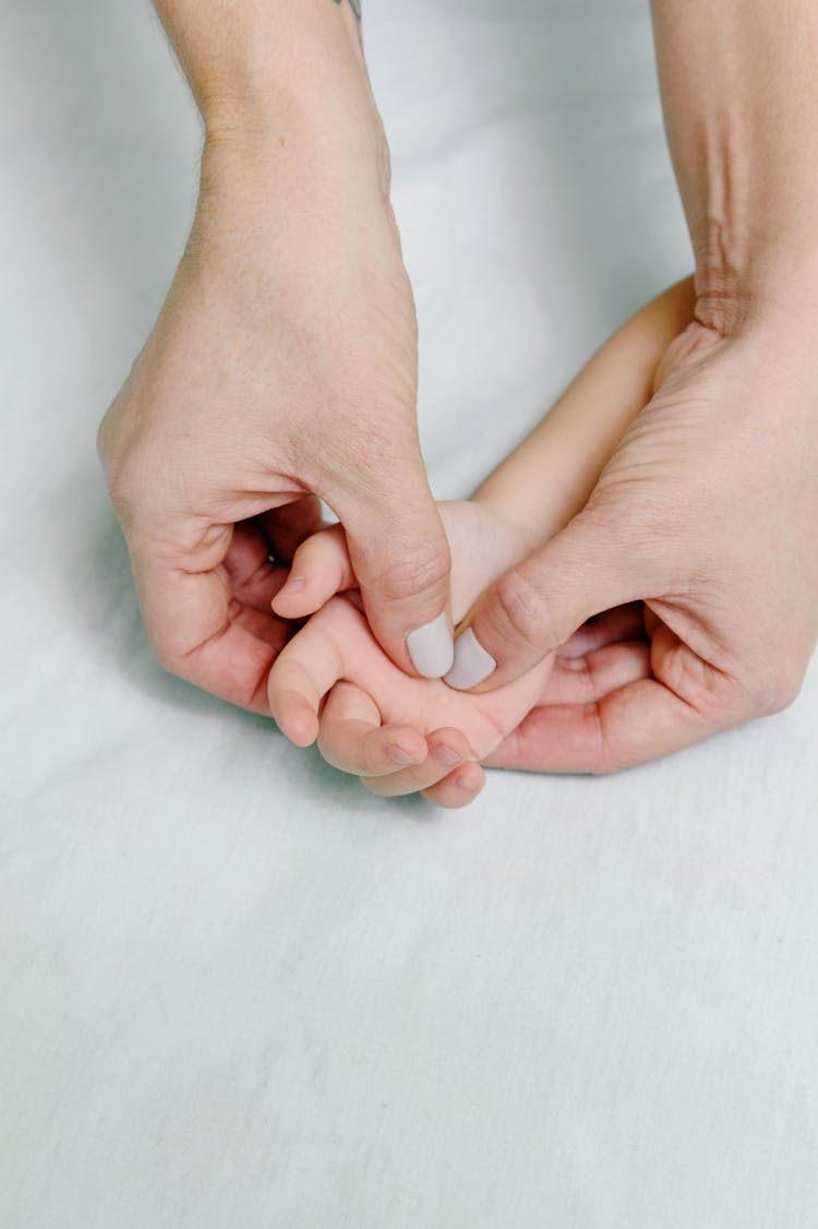 Close-Up Shot Of A Baby Getting A Hand Massage