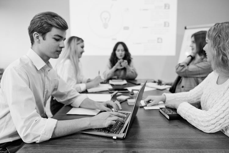 Grayscale Photo Of People Working Together