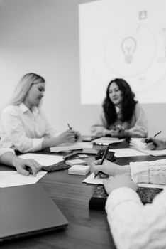 A group of colleagues engaged in a brainstorming session around a table, planning strategies.