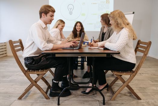 Colleagues having a lively discussion around a conference table in a modern office setting.