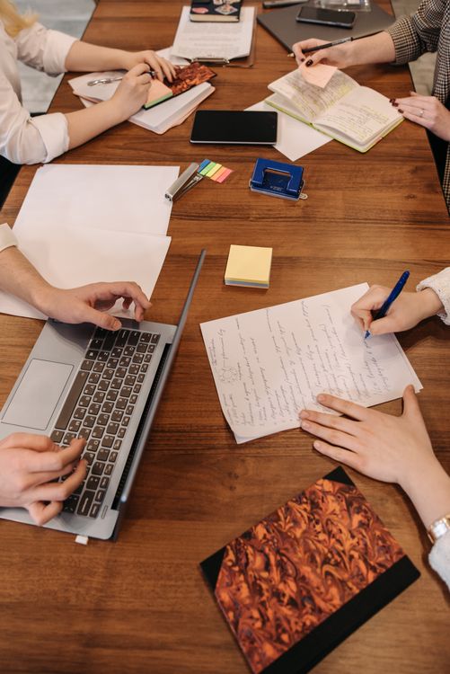 People Doing Their Own Tasks on the Wooden Table · Free Stock Photo