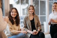 Woman in Brown Sweater Sitting Beside Woman in Brown Sweater