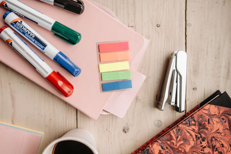 rotating desk caddy filled with pens, tape, and sticky notes