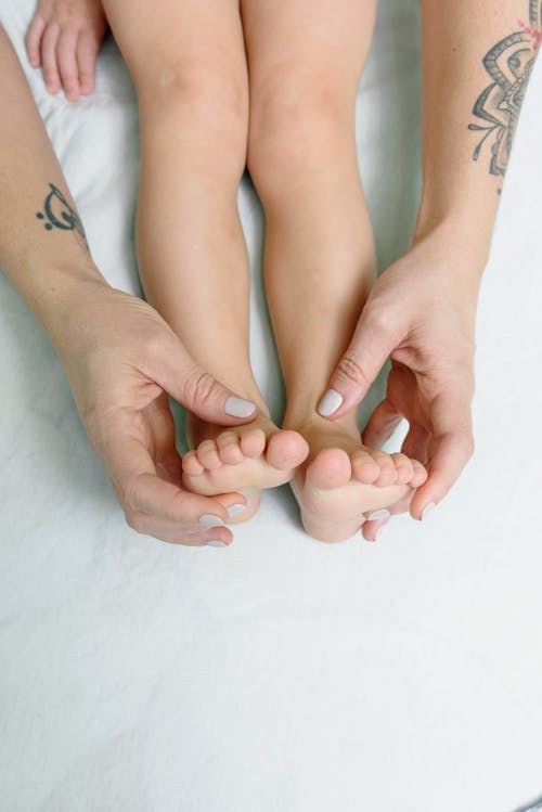 Hands Messaging the Kid's Feet 