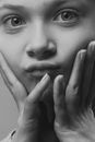 A Girl With Hands on Her Face