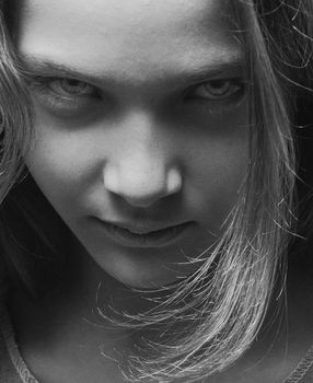 Grayscale close-up portrait of a woman with a strong gaze in Kyiv, Ukraine.