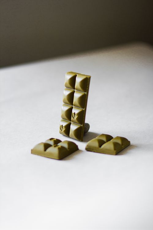 Free Composition of green tea chocolate bar pieces arranged on white table in studio Stock Photo