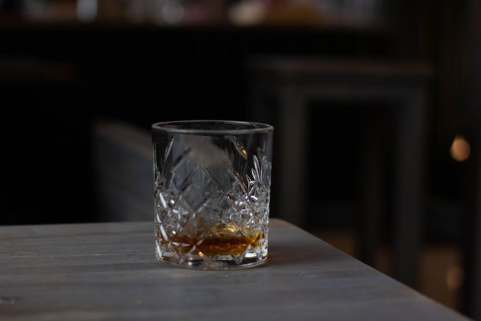 Amber spirit in cut glass on wooden table