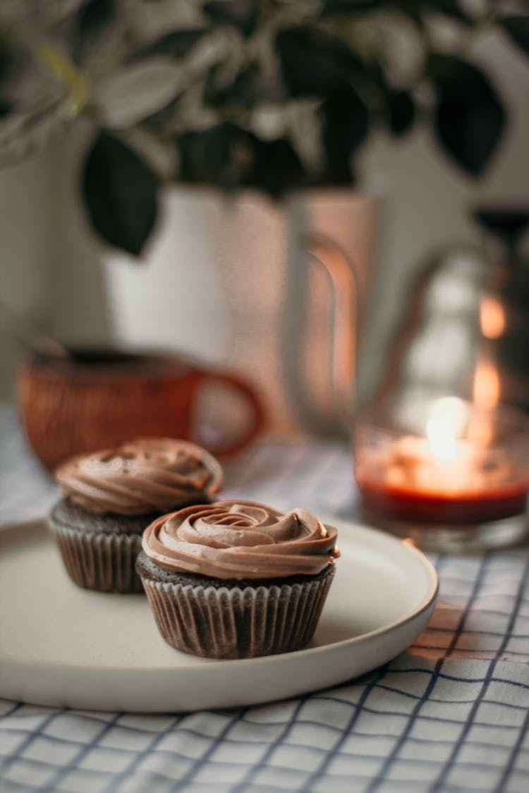 Sweet Cupcake On Plate Near Candle Tea And Plant