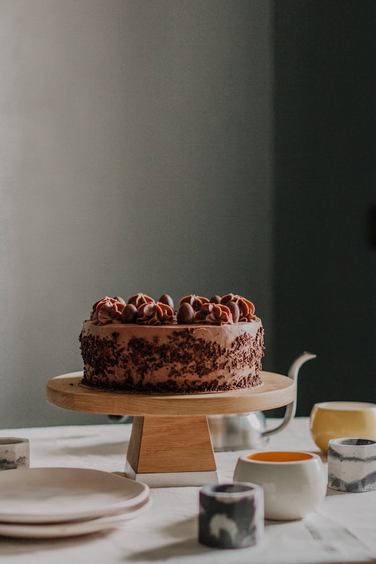 Delicious Dessert With Cream Topping On Wooden Stand