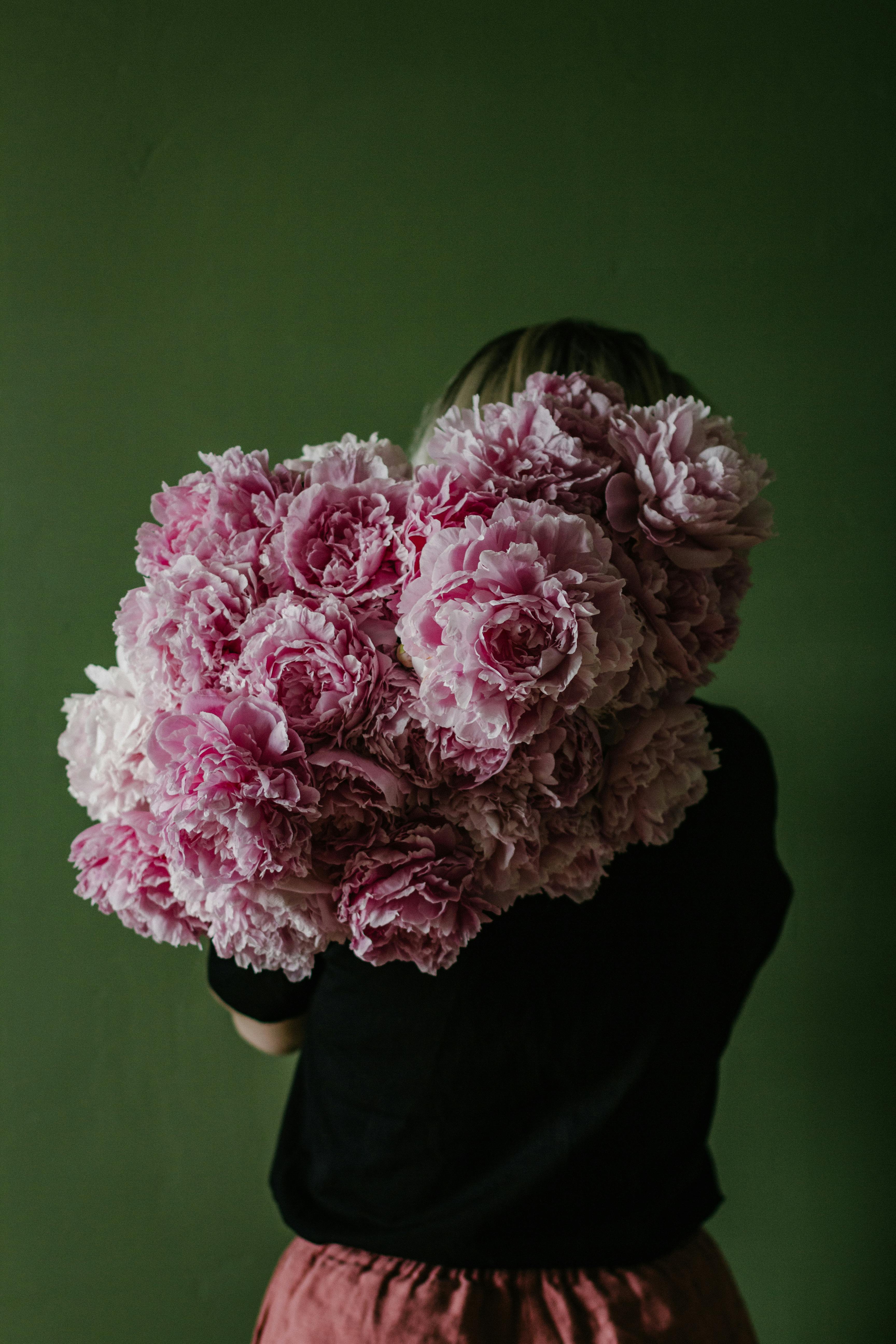 woman with bouquet of flowers on shoulder