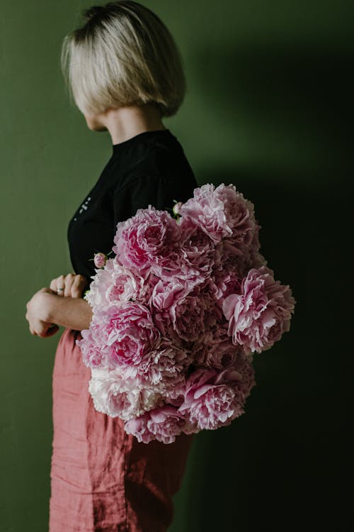 Gentle woman with bunch of flowers