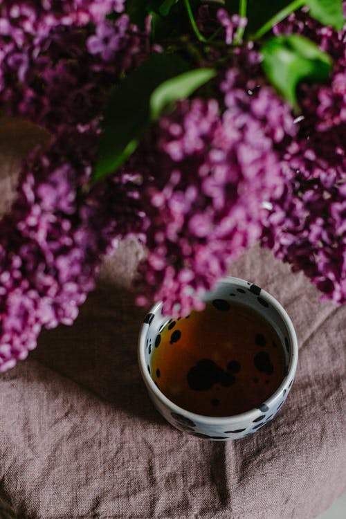 Free Fresh flowers in bunch above tea cup Stock Photo
