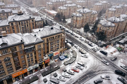 Aerial view of Qingdao's snow-covered residential buildings and streets in winter.
