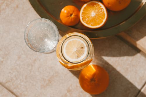 Free Top view of fresh citrus fruits and drink in sunlight, creating a vibrant and refreshing scene Stock Photo