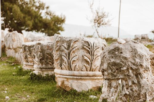 Free Row of ancient stone sculptures with intricate carvings in an outdoor archaeological site. Stock Photo