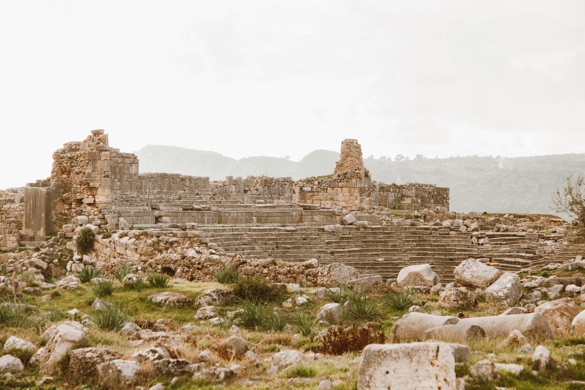 Explore the timeless beauty and historical significance of ancient stone ruins in a serene landscape.