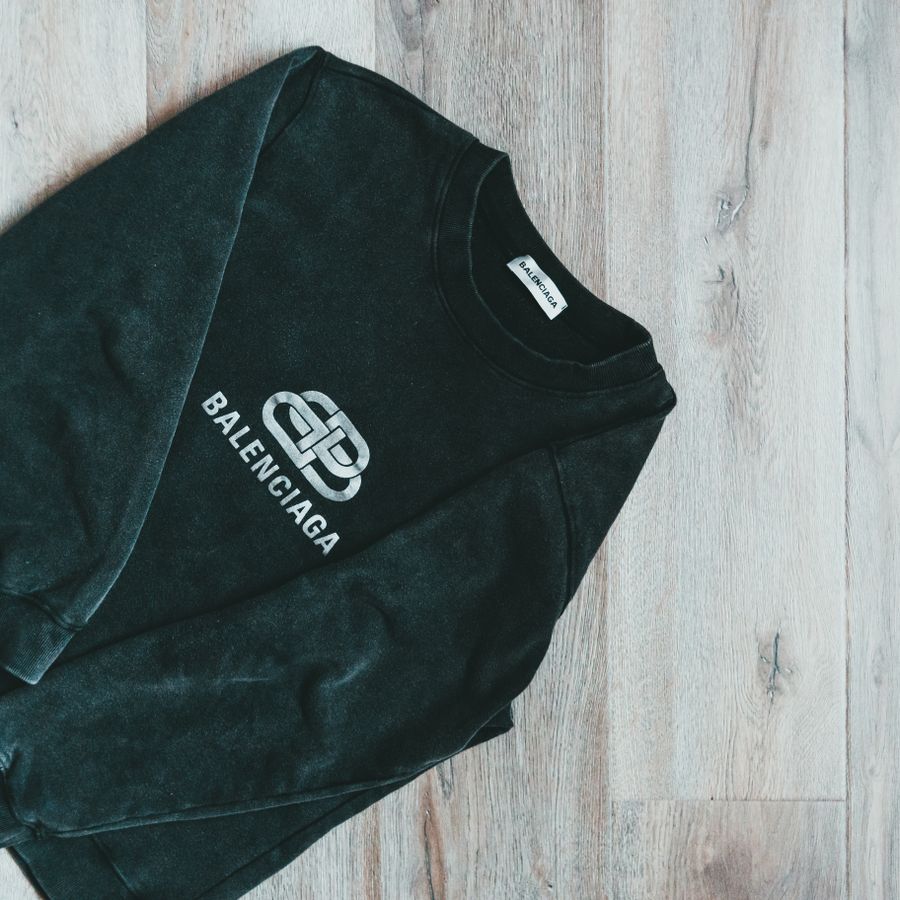 A dark long-sleeved top laid flat