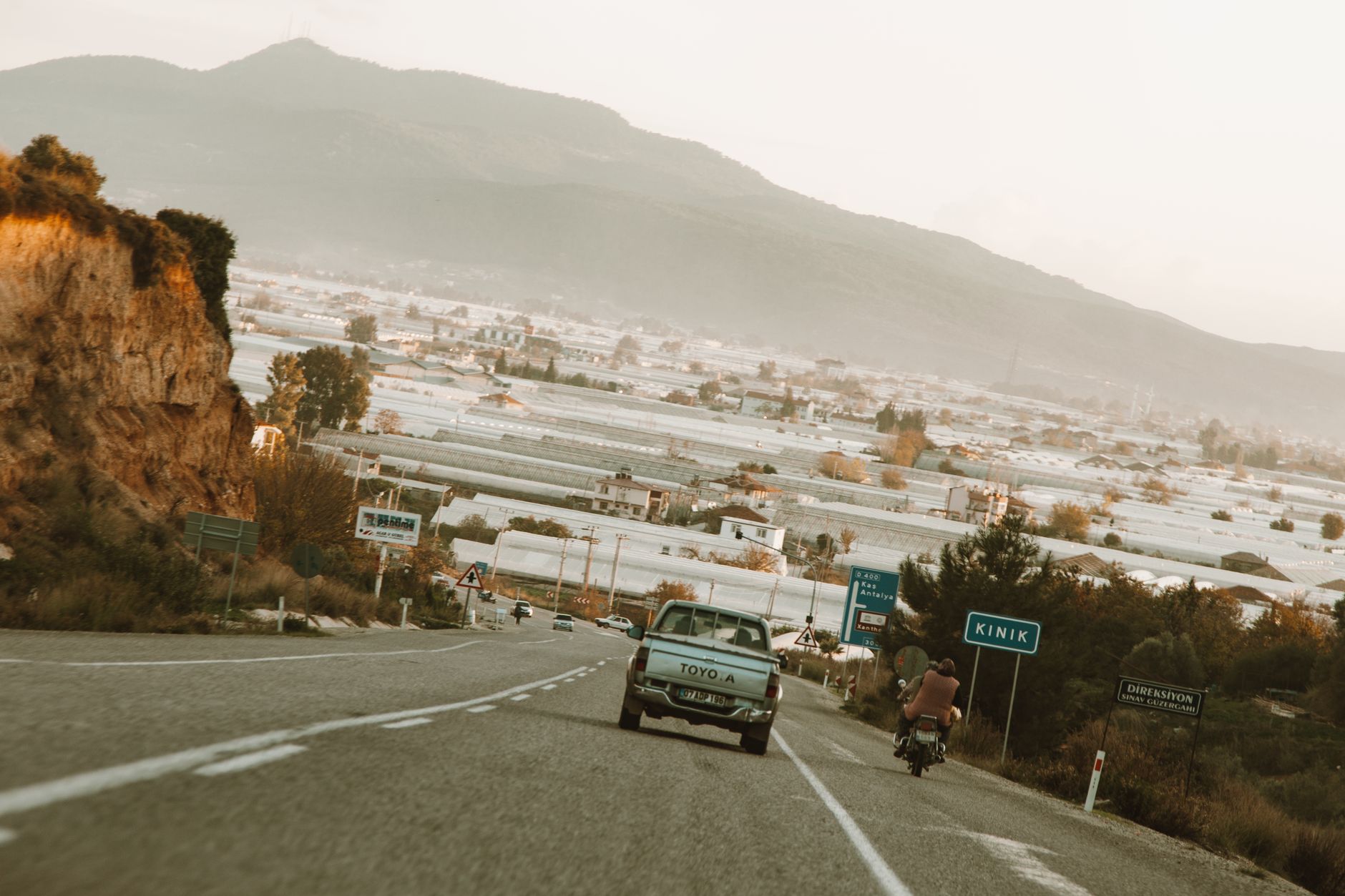 Explore the scenic road in Kinik with vintage car and motorbike. Perfect for travel enthusiasts.
