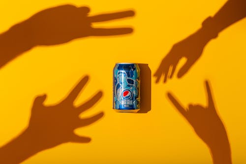 Hand Shadows Reaching for a Soda Can