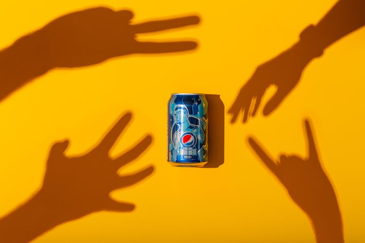 Hand Shadows Reaching For A Soda Can