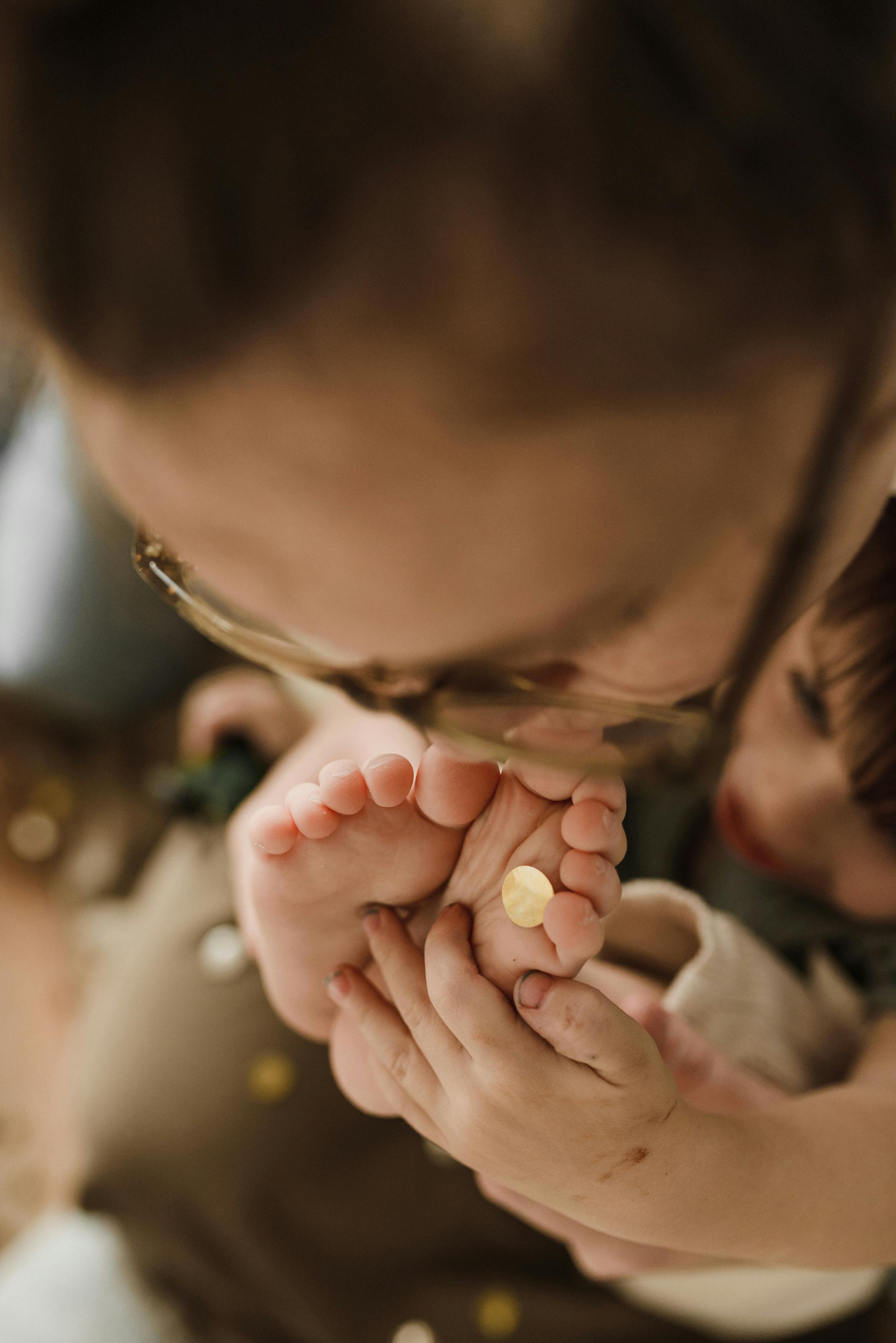 woman kissing a child s feet