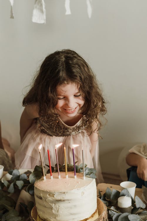 Free Little Birthday Girl Blowing Out Candles Stock Photo