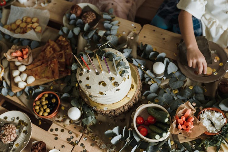 Birthday Cake Among Food On A Pallet Table