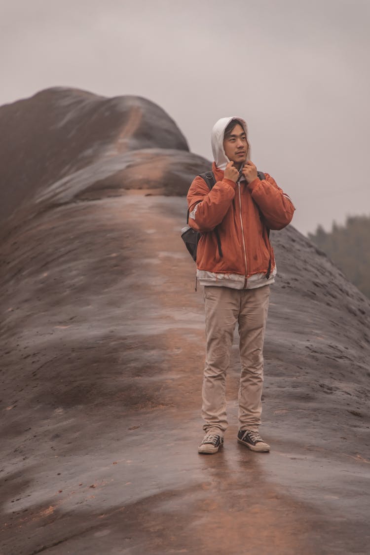 Man Standing On Mountain Slope