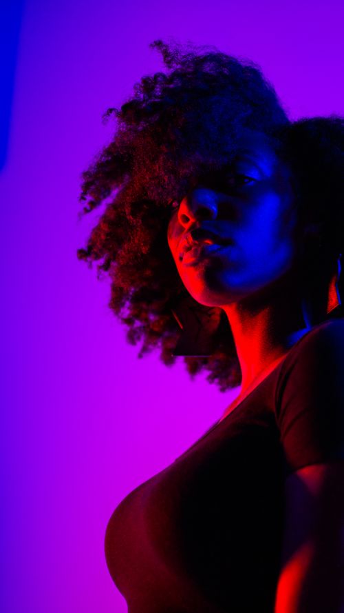 Silhouette of Woman Against Purple Background · Free Stock Photo