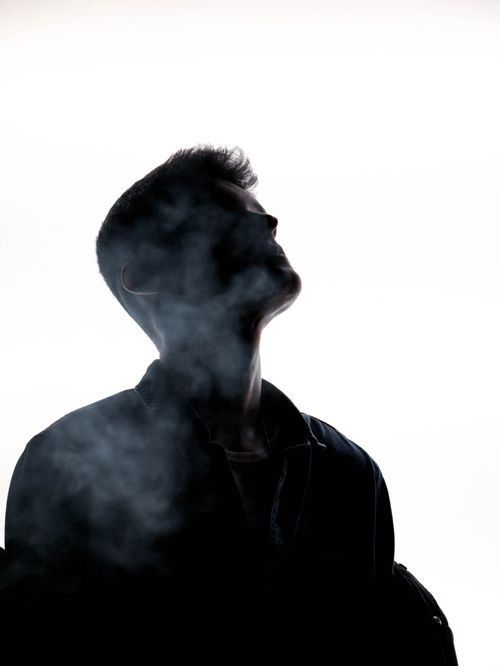 Free Silhouette of a man in smoke, creating a mysterious and dramatic scene. Stock Photo