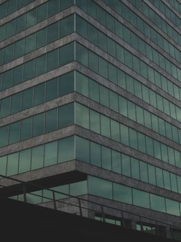 Striking angled view of a modern building's glass facade in Almere, Netherlands.