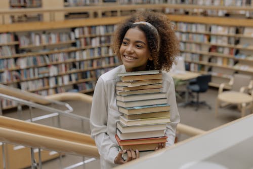 Free Photo Of Woman Carrying Stack Of Books  Stock Photo