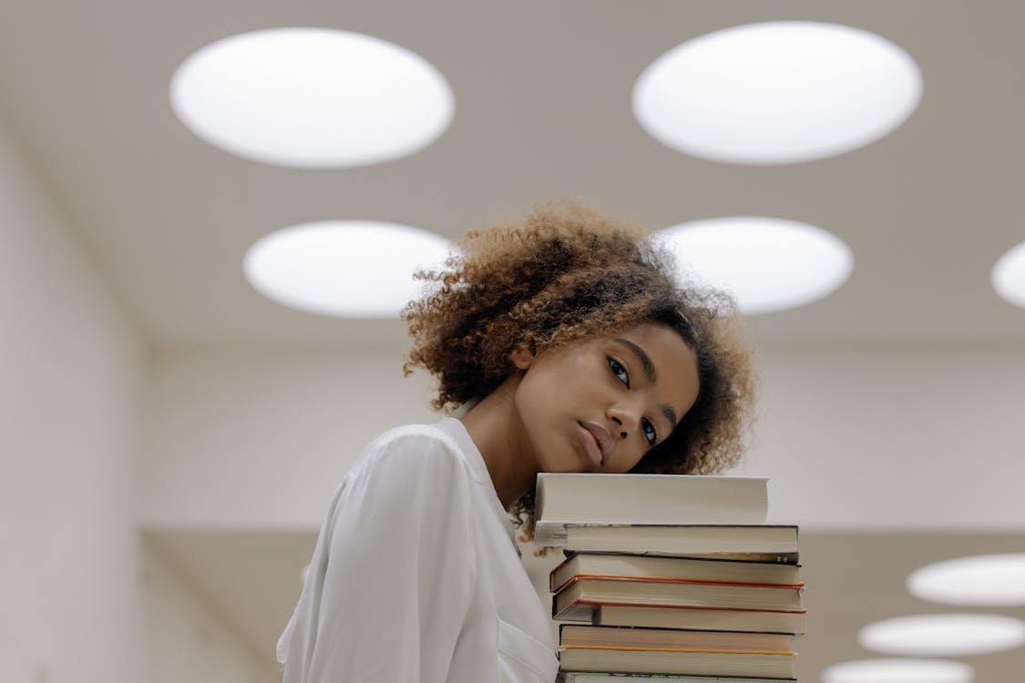 Free Photo Of Woman Carrying Books Stock Photo