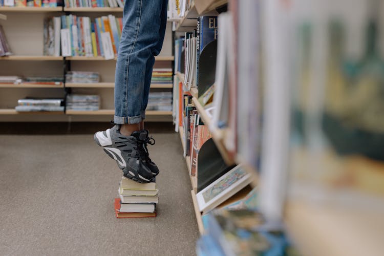 A Person Standing On The Books