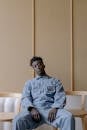 Man in Blue Jumpsuit Sitting on a Chair