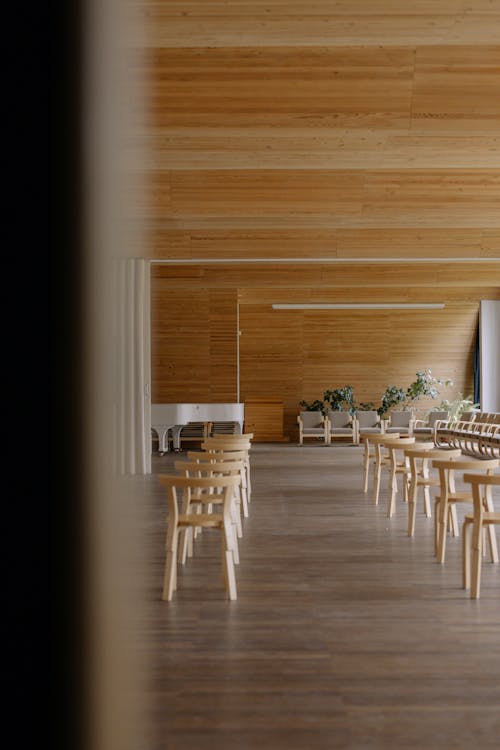 Wooden Chairs in Rows Inside a Room