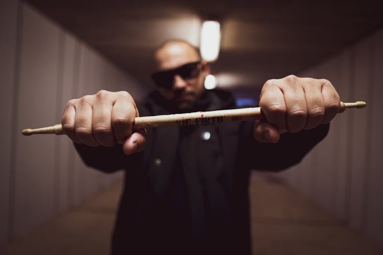 A Man Holding A Drumstick