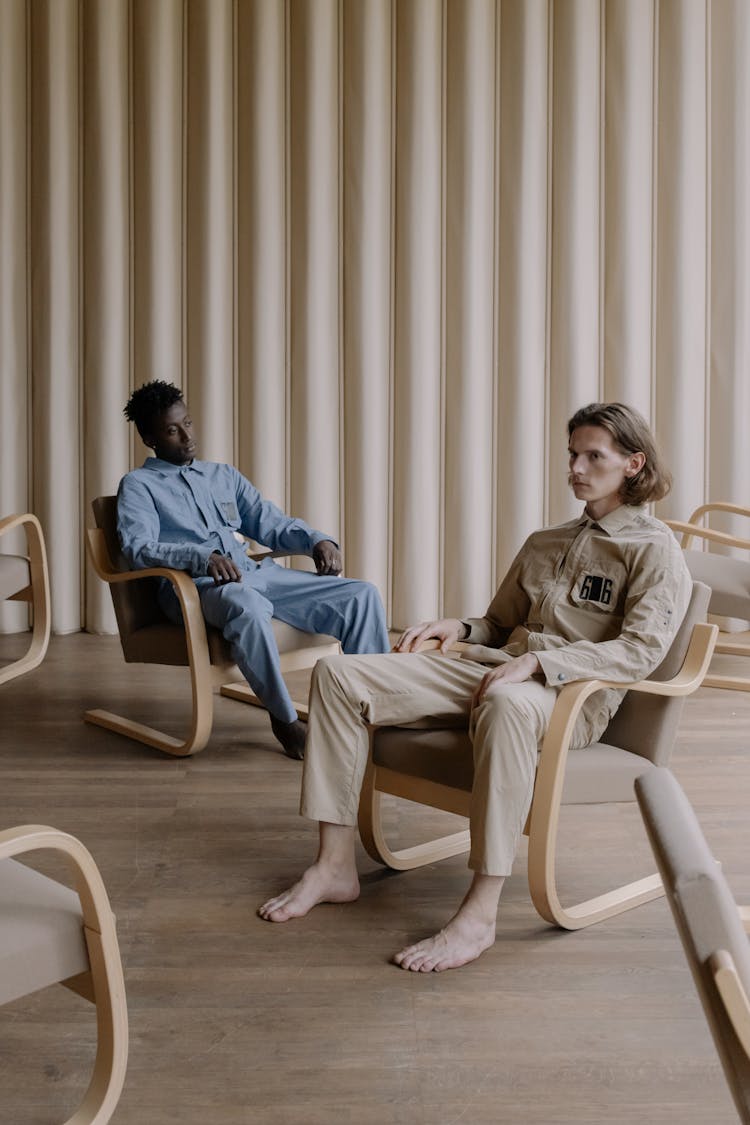 Men Sitting On Brown Chairs