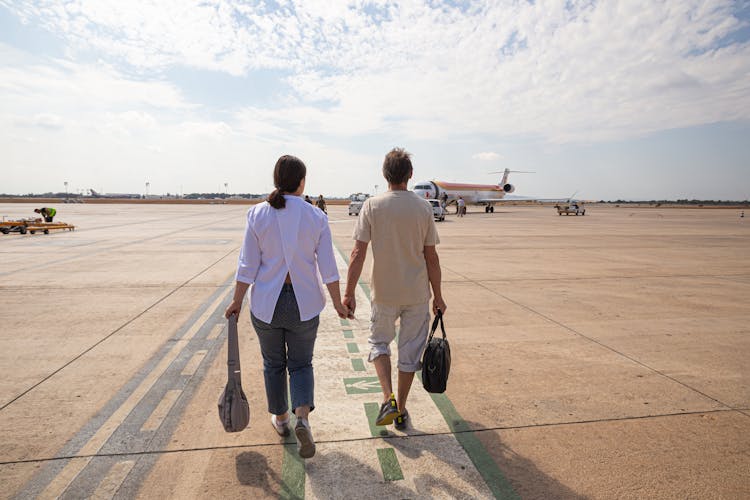 Couple Walking In The Airport