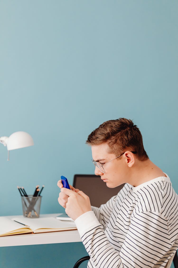 A Man Holding A Calculator