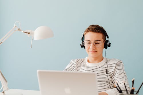 Teenage Boy in Headphones Working on Computer