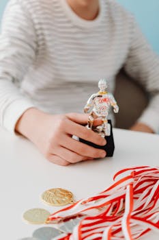 Teen in striped shirt holding soccer trophy with gold medals, symbolizing sports achievement.