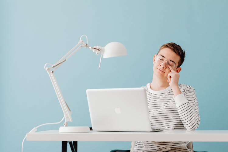 Tired Guy Sitting On Laptop Overwhelmed With Computer Work