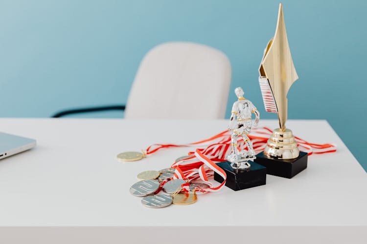 Trophies And Medals On A White Table