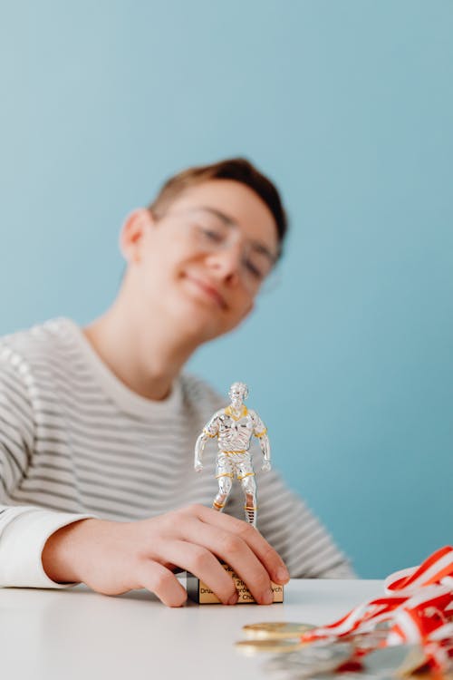 Smiling Boy with Toy Figurine