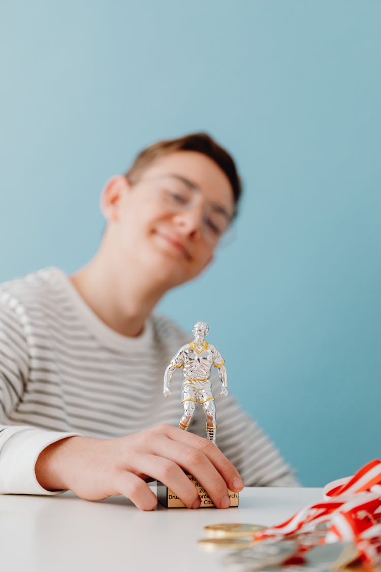 Smiling Boy With Toy Figurine