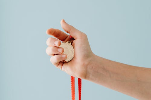 Hand Holding Medal